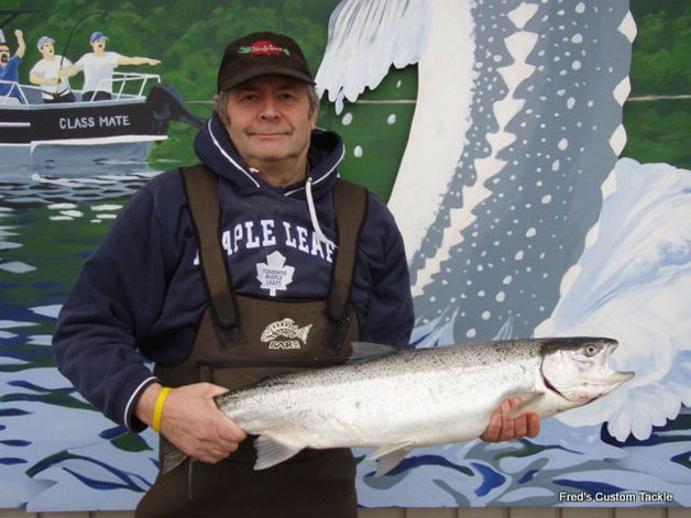 Chris Gadsden weighing in his steelhead at Fred's Custom Tackle